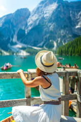 Fototapeta premium Tourist enjoying breathtaking view of lake braies in dolomites, italy