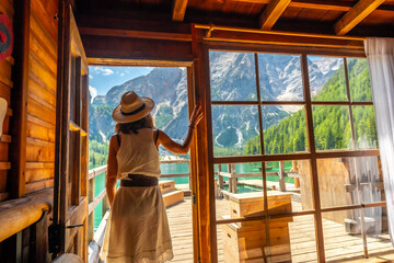 Tourist enjoying breathtaking view of lake braies in dolomites, italy