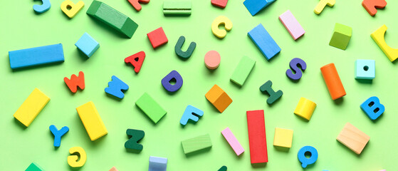 Wooden letters with colorful blocks on green background. Children's Day celebration