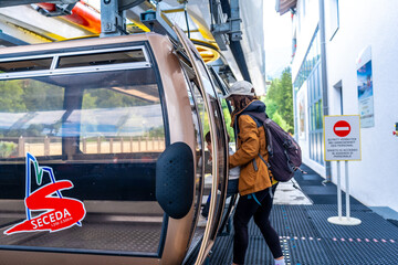 Tourists entering cable car at seceda in the dolomites