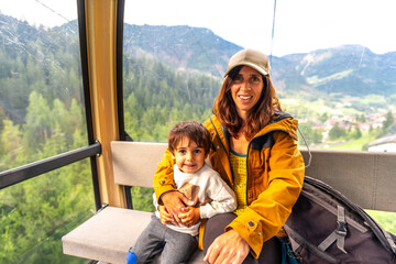 Mother and son enjoying cable car ride in the dolomites © unai