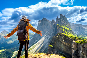 Female hiker embracing the majestic seceda peaks in the italian dolomites