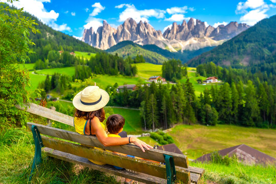 Tourists admiring odle mountains in val di funes, dolomites, italy