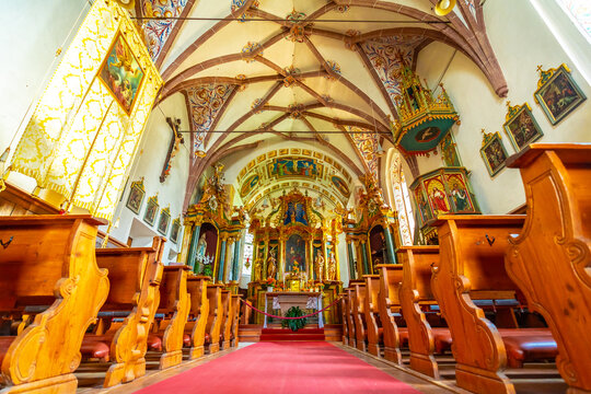 Interior of the church of st. Magdalena in val di funes showing frescoes and pews