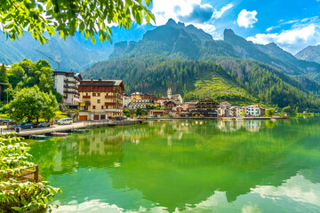 Naklejka premium Picturesque village of alleghe reflecting on lake alleghe in the italian dolomites