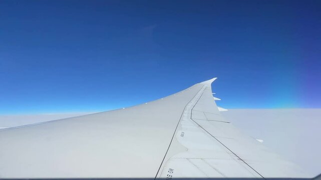 AERIAL VIEWS FROM INSIDE AN AIRPLANE TO THE EXTERIOR