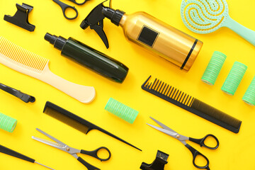 Set of hairdresser's accessories on yellow background