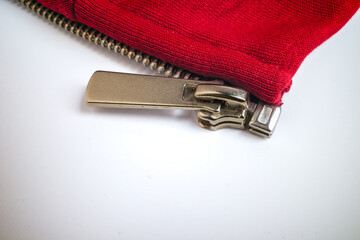 Close-up of metallic zipper on red fabric