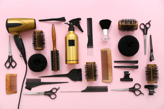 Different hairdresser's accessories on pink background