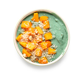 Bowl with tasty spirulina smoothie and pieces of pumpkin on white background