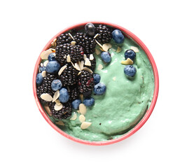 Bowl with delicious spirulina smoothie and berries on white background