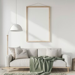 A white sofa with a green throw blanket in a minimalistic living room with a large empty frame on the wall