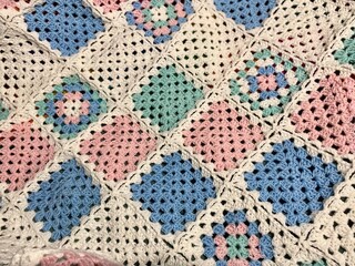 Granny square crocheted blanket with different colors motives, retro vintage craft handmade handiwork crocheting, beautiful plied photo cozy winter or autumn background wool thing yarn lovely warm