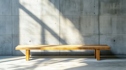 Minimalist wooden bench against a textured concrete wall.