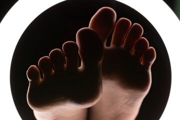female legs close-up in a round lamp.the concept of hygiene and care.foot fetishism