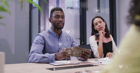 Image of data processing over diverse business people talking in office