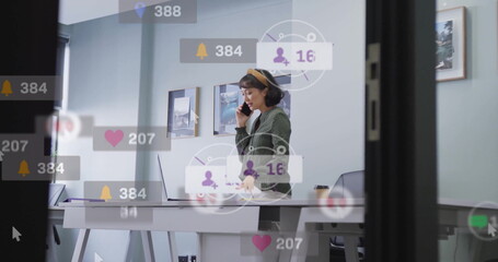 Image of data processing over biracial businesswoman talking on smartphone in office