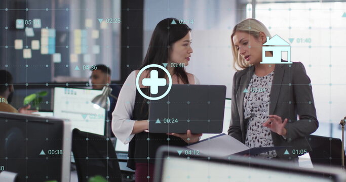 Image of data processing over diverse female colleagues discussing work in office