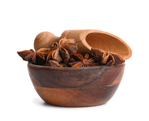 Wooden bowl with aromatic star anise and scoop on white background