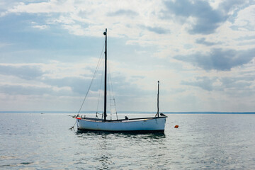 Fototapeta premium Small Ship Sailing in Sea at Sunny Day