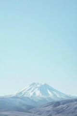 A serene mountain landscape under a clear blue sky.