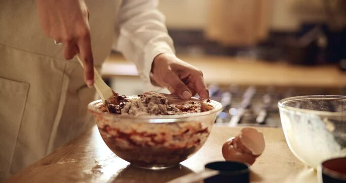 Hands, woman and mixture for baking in kitchen with meal prep, dessert process and organic breakfast. Female baker, whisk and cooking snack of chocolate cake, ingredients and culinary skills at house