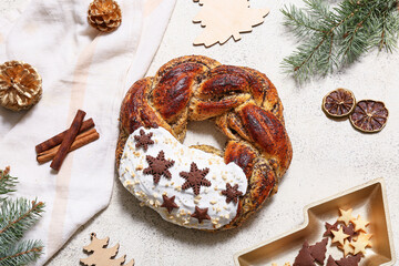 Tasty Christmas pastry wreath with fir tree branches, decor and cookies on white background