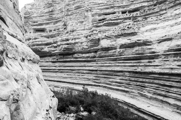 A rocky cliff with a small stream running through it