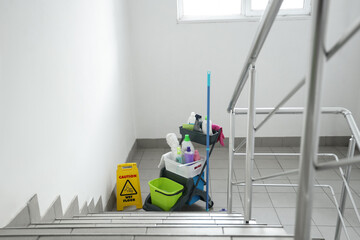 Trolley with cleaning supplies in stairway