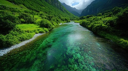 A crystal-clear river winding through a lush valley