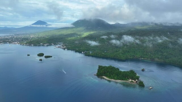 Calm water flows through Lembeh Strait, separating North Sulawesi from Lembeh Island. This tropical area is home to a plethora of marine biodiversity and is popular among divers.
