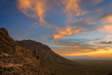Breathtaking desert landscape showcasing rugged mountains under a vibrant sunset sky. The scene captures the tranquility and beauty of nature, offering a sense of peace and wonder.