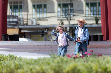 An elderly couple walks around the street in the old city of Bangkok, Thailand.