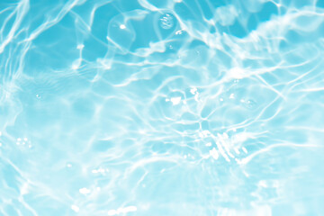 Blue water with ripples on the surface. Defocus blurred transparent blue colored clear calm water...