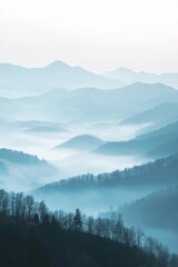 Serene mountain landscape shrouded in mist and soft blue hues.