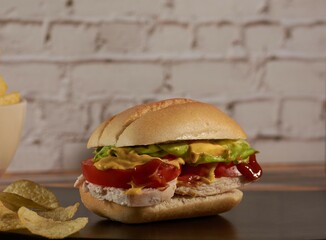 sandwich with chicken ,vegetables, and sauces
