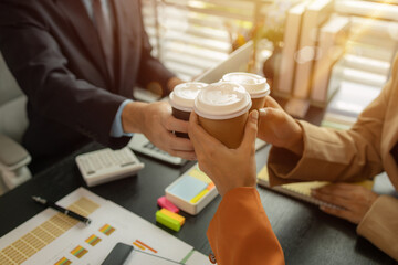 a group of businessman is meeting in the office in the morning with their coffee, colleagues sit together having some coffee in the workplace, businesspeople discussion about their new project