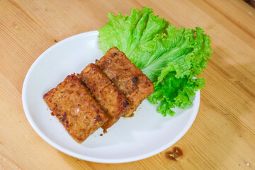 Tempe Bacem is a traditional food of Central Java, the tempeh is flavored with brown sugar and then fried, served on wicker bamboo plate