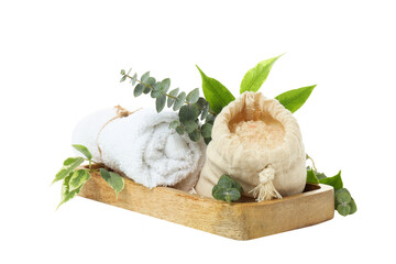 Towel, sea salt in bag and leaves on wooden board on white background, close up