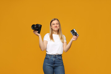 Beautiful girl photographer in the photo studio, on a yellow background.