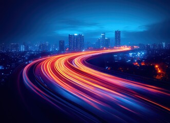 Fototapeta premium Night cityscape with vibrant light trails of speeding cars on a highway curving through the city, showcasing modern urban development and fast-paced life.