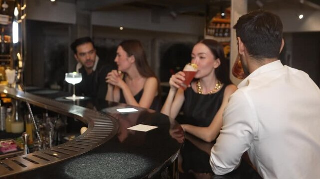 Couple making a toast with cocktail paloma and old fashioned at luxurious bar in lively conversation drinks celebrating a special party at vibrant nightclub while friend drinking Margarita. Vinosity.
