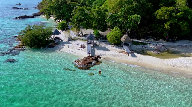 Explore the beauty of Koh Munnork Island, where crystal-clear waters meet soft sandy beaches. Enjoy the lush greenery and tranquil ambiance during a perfect day of relaxation. couple on the beach