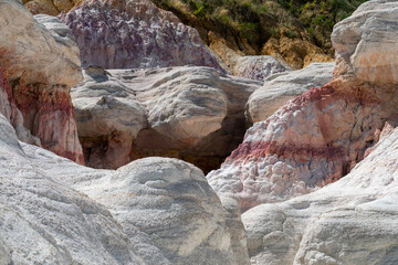 Unique rock formations and colorful geological patterns in a remote area showcasing the beauty of nature's sculpting in vibrant hues during midday