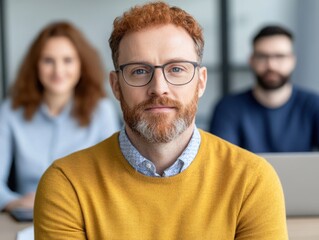 Fototapeta premium Focused Businessman with Glasses in Yellow Sweater, Team Members in Background, Professional Office Environment, Collaborative Workplace Atmosphere