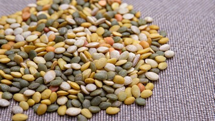 Fototapeta premium Mixed Assorted Seeds on a Textured Fabric