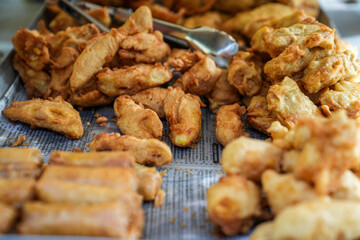 A tempting spread of traditional Indonesian fried snacks, including crispy fried bananas and other golden delights, served on paper. Perfectly crunchy and packed with nostalgic flavors