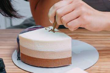 Cooking mousse cake at a cooking class. Cooking at home, home-made food. Demonstrating the colors of 2025 year - Mocha Mousse