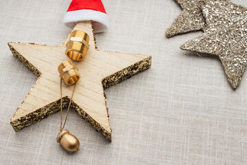 Christmas wooden star with a red cap. Brass hydraulic connectors
