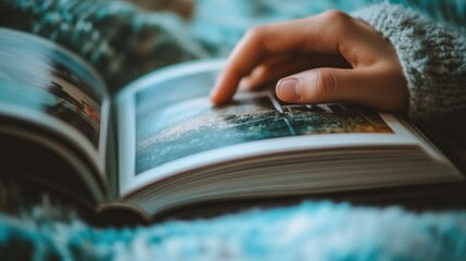 A Hand Reaching Out to Touch a Photo in an Open Book